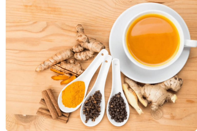 Spoons filled with turmeric, black pepper and ginger
