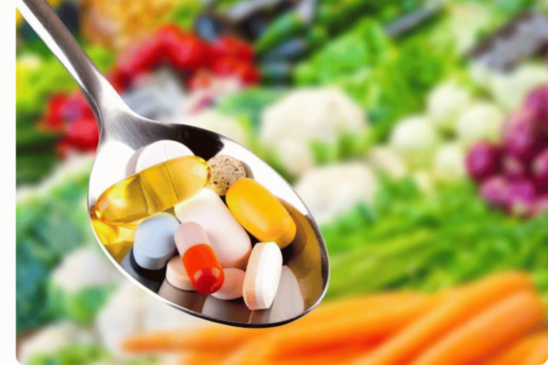 Spoonful of tablets and capsules of vitamins