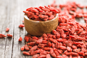a photo depicting a bowl full of red goji berry